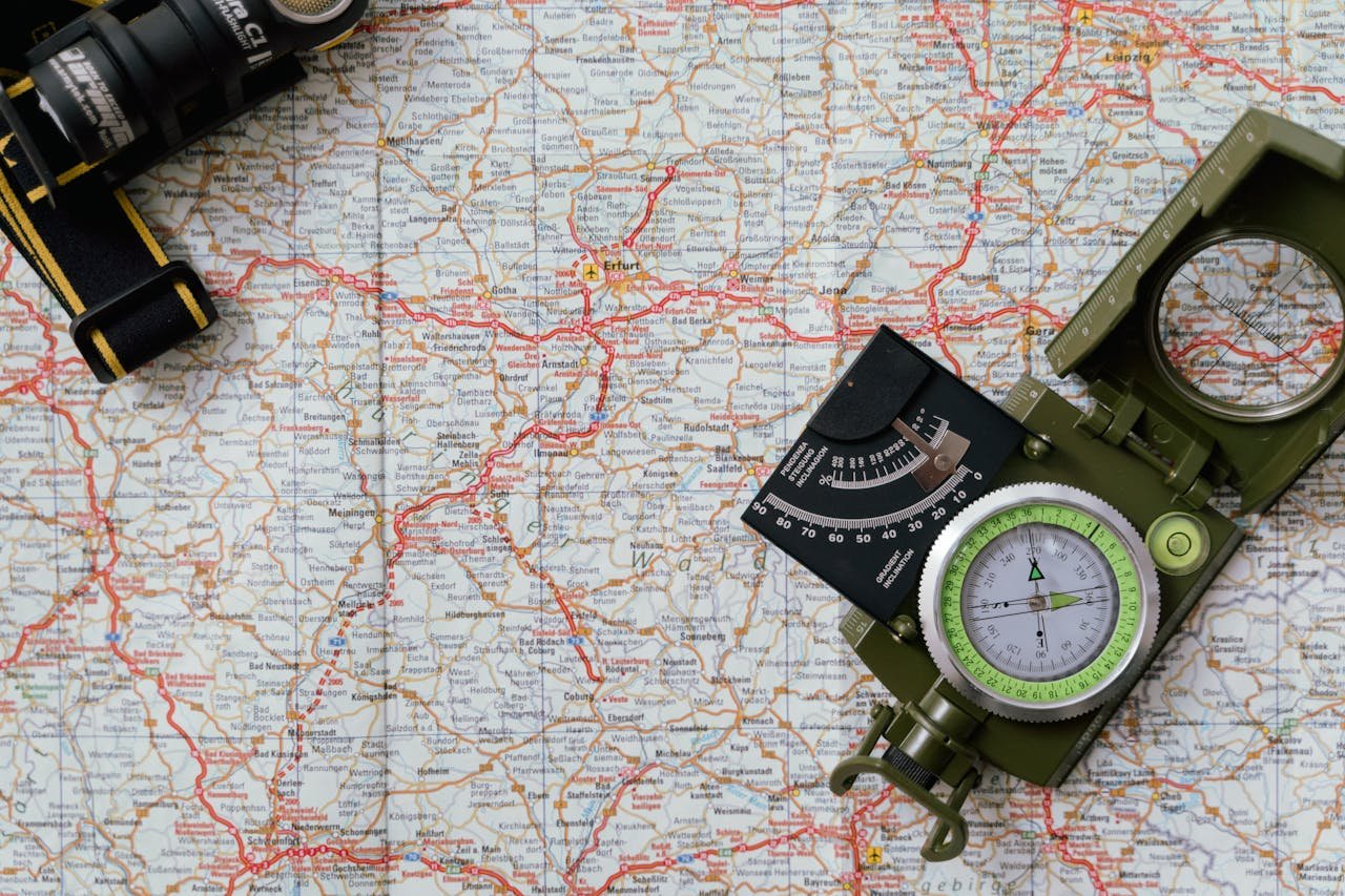 Close-up view of a compass on a detailed map, ideal for travel and navigation concepts.